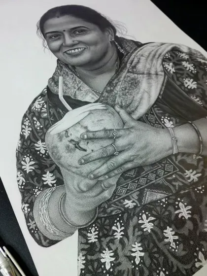 A closer look at the hyper-realistic sketch for the client from Lucknow. You can see the fine lines and shading on the fabric and her hands.
