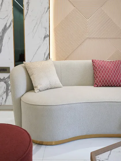 The subtle gold trim at the base of the sofa is a small detail that adds a significant touch of luxury. It’s all about these thoughtful finishes.