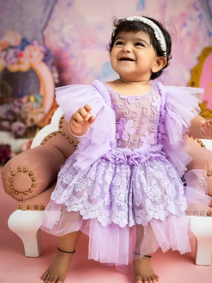 The purest smile from our little princess. The soft lighting and delicate lace dress create an angelic portrait that parents will cherish forever.