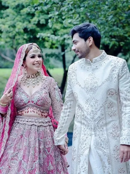 A classic wedding photo of the couple holding hands.