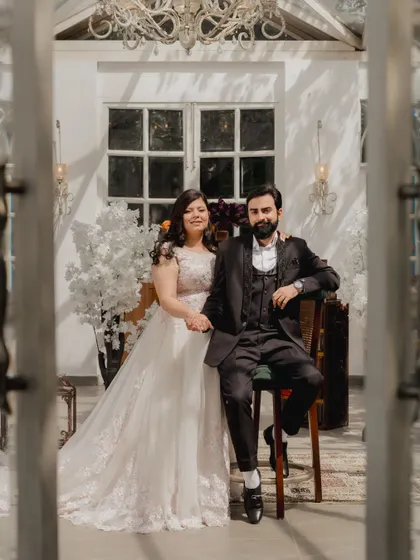 A beautifully framed shot of the couple through a doorway, giving a sense of intimacy and a peek into their world.