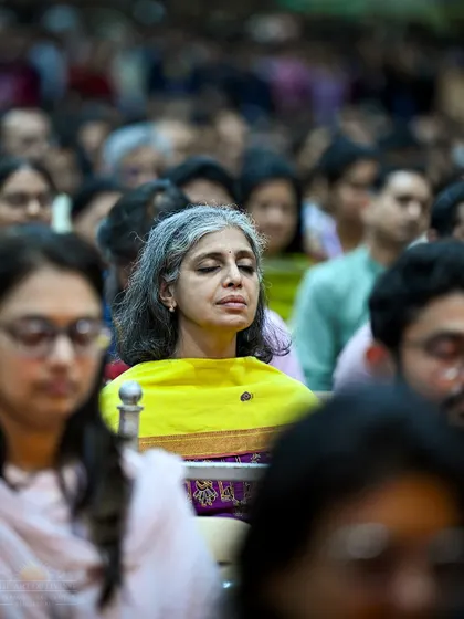 A participant in deep meditation during the Patanjali Yoga Sutras discourse. The knowledge sessions are interwoven with powerful guided meditations to provide an experiential understanding of the concepts.