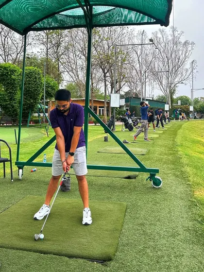 A golfer takes a practice swing in one of our covered bays, a perfect spot for focused training.