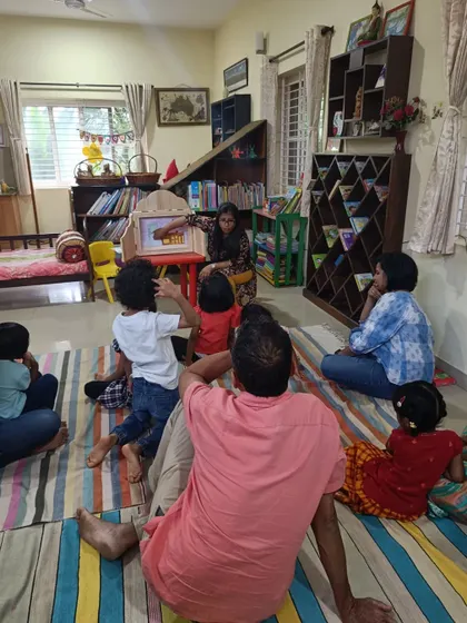 The children are eager to see what happens next in the puppet show about flying birds.