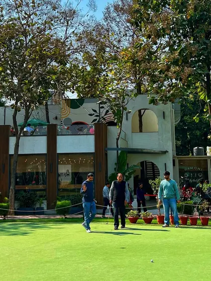 A beautiful day for a celebration on the greens. Guests enjoy a casual putting session with our modern clubhouse in the background.