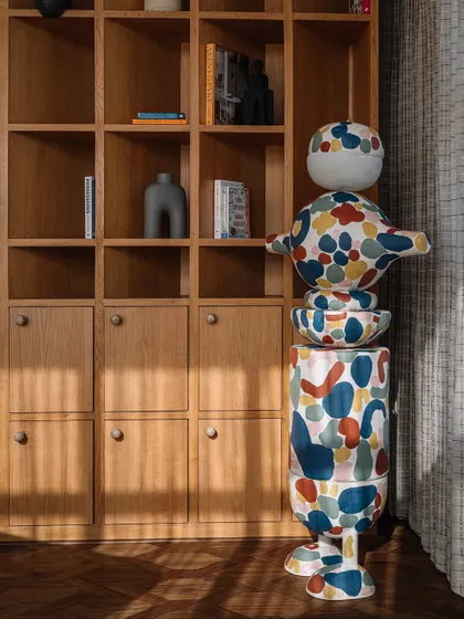 This custom 'MuseTRIBE' floor lamp is a scaled-up version of the wooden toys we designed with Channapatna artisans. We collaborated with an artist to hand-paint the lamp, turning it into a vibrant, oversized sculpture that brings life to the library.