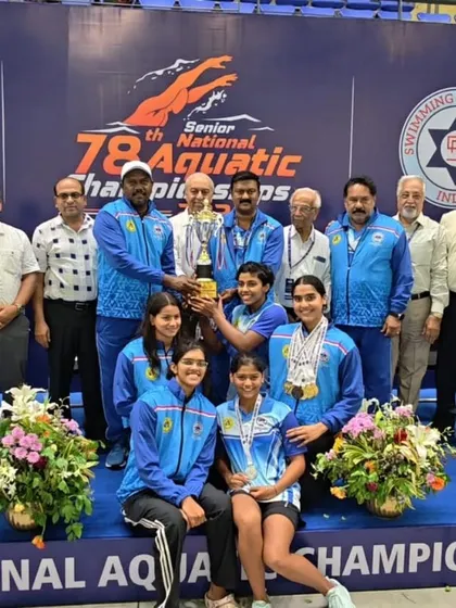 The women's team and coaches with their well-deserved championship trophy.