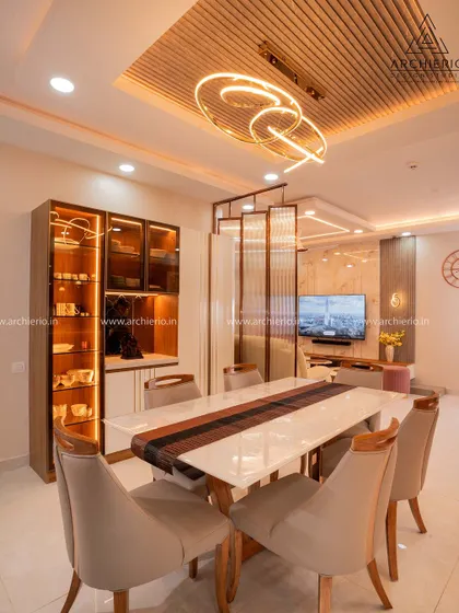 Another view of the dining area, highlighting the fluted wood ceiling panel and the seamless connection to the living room.