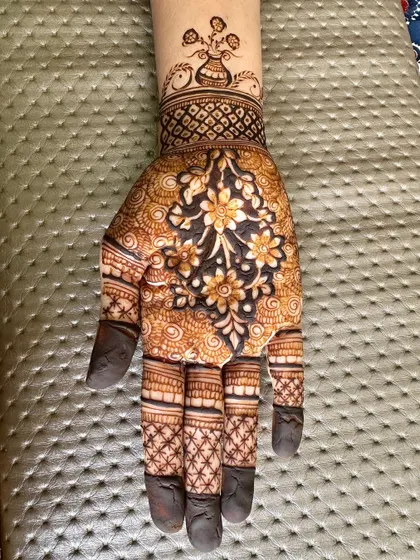 A close-up of the hand with the floral cluster.