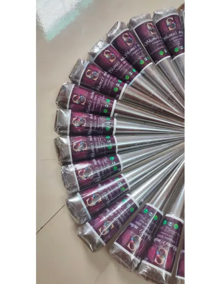 A fan of freshly made henna cones, showing the consistent size and shape I create for each one. The silver wrapping helps keep the essential oils from drying out, ensuring the paste stays potent.