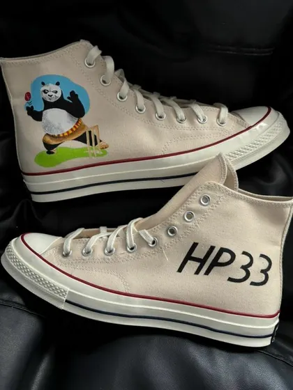 A detailed view of the Hardik Pandya custom Converse, featuring a cartoon panda and his jersey number "HP33."
