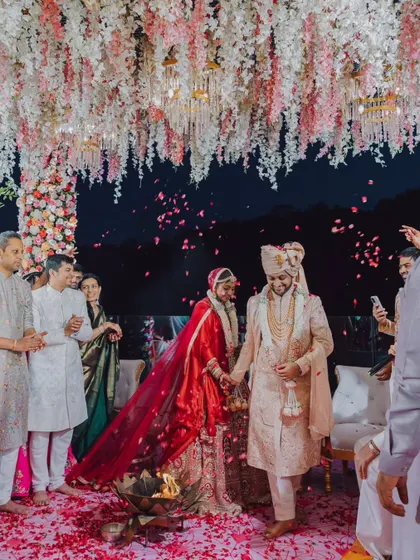 The couple takes their first steps together as husband and wife around the sacred fire. This shot captures the significance of the Pheras and the beginning of their shared path.