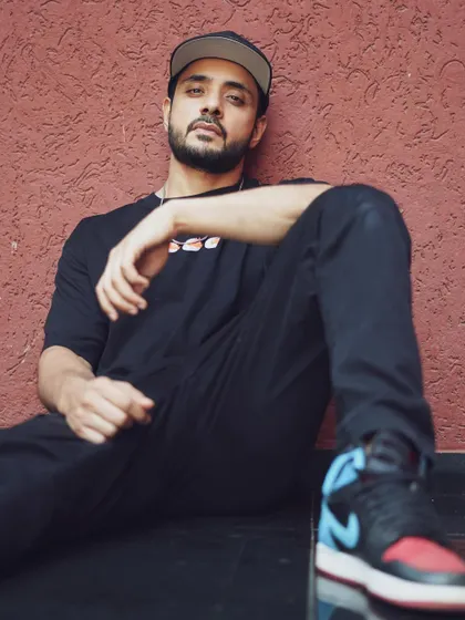 A full-length shot of actor Adnan A. Khan, capturing his relaxed, street-style persona. This kind of environmental portrait helps in building a relatable brand for an actor.