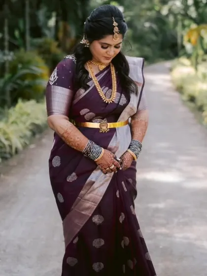 Our client Shanvi looking graceful during her engagement ceremony in a deep purple silk saree with silver zari work.