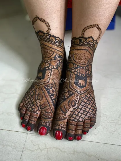 Another angle of the intricate bridal feet design. The red nail polish provides a beautiful contrast to the dark henna.