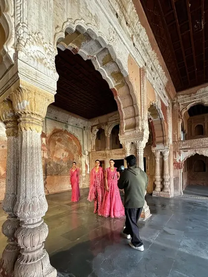 The reality of a campaign shoot. This wide shot shows the entire crew, lighting setup, and models in position, giving a true sense of the teamwork required to create the final images.