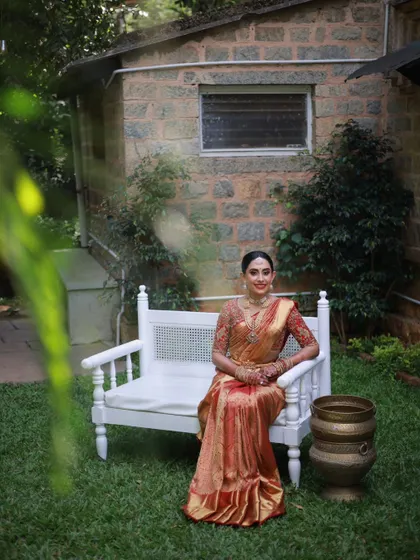 A serene bridal portrait. The makeup is kept classic and elegant, with an emphasis on radiant skin and defined features that enhance the bride's natural beauty in her stunning Kanjeevaram saree.