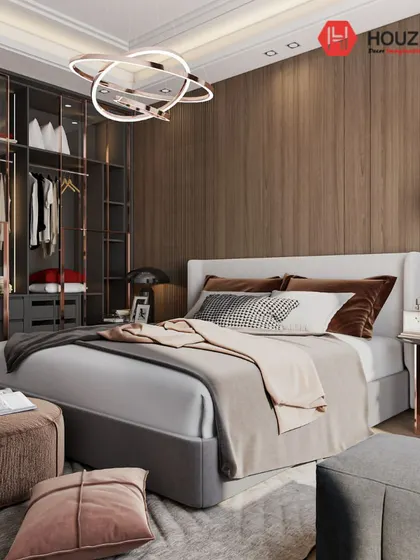 A repeat image of a modern bedroom with a walk-in closet featuring glass and rose gold frames. This design is a great example of how we integrate luxury and practicality.