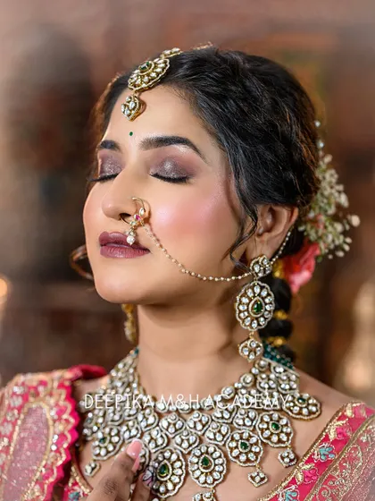 A close-up focusing on the bride's eye makeup and her traditional nose ring (nath). The smoky eye adds a touch of drama to the look.