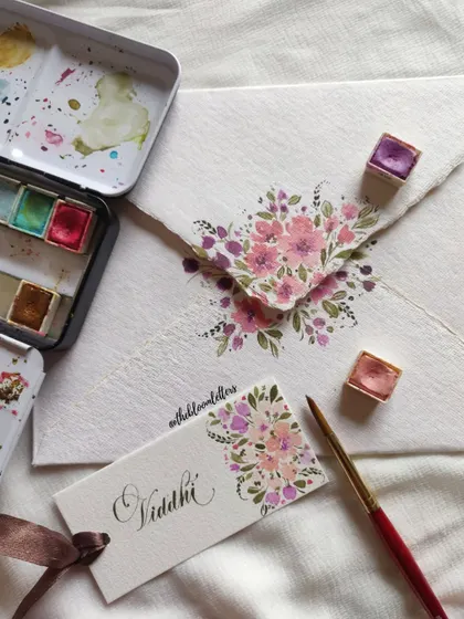 A detailed shot of a hand-painted name tag and matching envelope, created as a token of gratitude for one of my mentors.