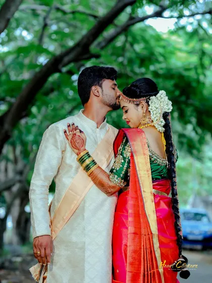 A loving embrace under a canopy of trees. The bride's radiant smile and traditional jewelry shine, capturing a moment of pure happiness before the wedding.