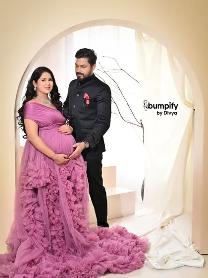 This mom to be looks absolutely radiant in a ruffled purple gown. Our studio provides the perfect elegant backdrop to make you feel like you're on a red carpet.