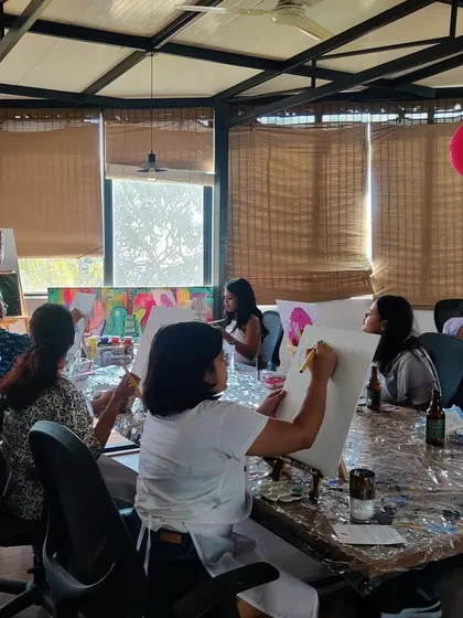 A wide shot of our gold leaf open house workshop. The room is buzzing with creativity as everyone adds a bit of sparkle to their paintings.