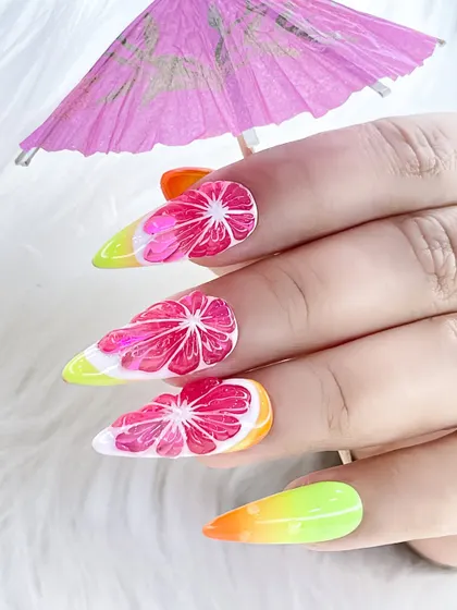 Another shot of the watermelon nails, highlighting the sharp stiletto shape and the refreshing, fruity design.