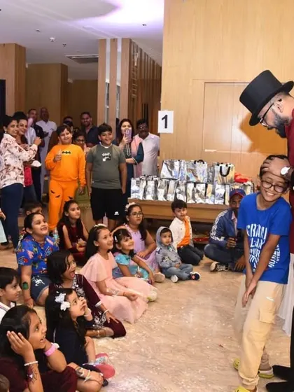 A quiet moment of interaction with the birthday boy before he helps me with the next big trick. Building a connection with the kids is key to a great interactive show.