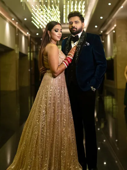 A reception bride in a stunning gold gown. The makeup is a dramatic green smokey eye, adding a unique and modern touch to her look.