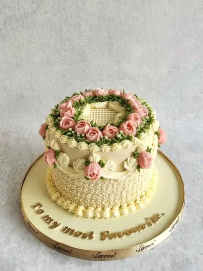 This cake showcases the beauty of buttercream piping, with a wreath of delicate pink roses and intricate scrollwork on the sides. This vintage style is making a comeback, and I love teaching the piping skills needed to create it.
