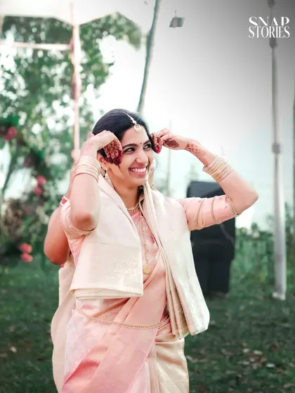 A happy, candid shot of the bride adjusting her hair. We look for the in-between moments that show personality and grace.