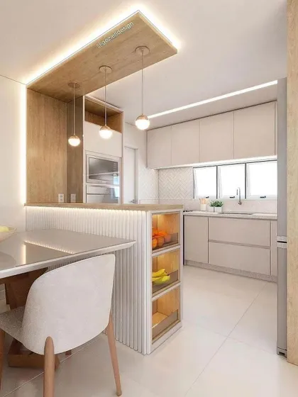A bright and airy kitchen design in beige and light wood tones. The peninsula includes open, lit shelving for easy access to everyday items.