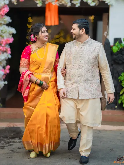 A full-length shot of a Maharashtrian couple taking a walk after their ceremony, showcasing their elegant traditional outfits.