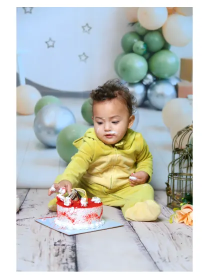 Getting his hands into the cake during the first birthday smash.