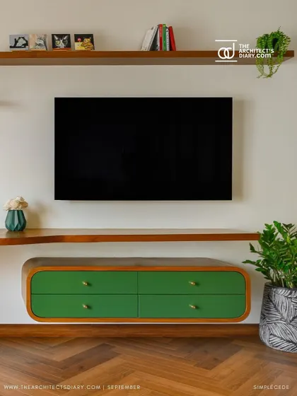 A floating TV console from 'Cover me in Sunshine', featuring a vibrant green finish and curved edges. This piece adds a playful pop of color and a touch of modern design to the master bedroom.