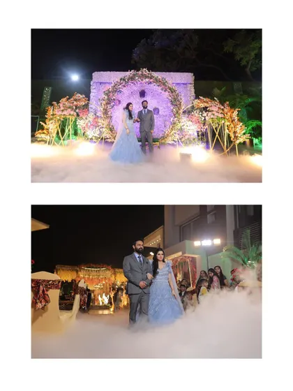 The couple's grand entrance at their engagement party, set against a beautiful floral arch and a cloud of fog for a dramatic and romantic effect.