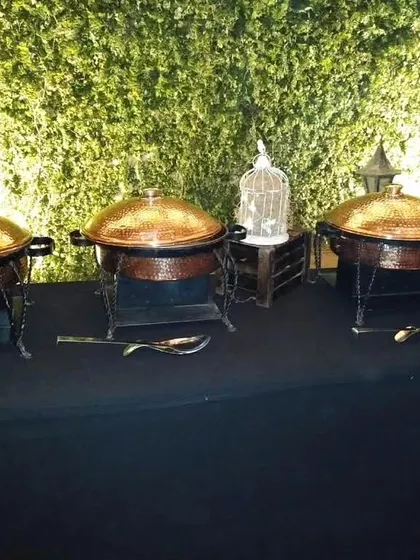 A whimsical birdcage prop placed among our classic copper serving dishes. These small decorative details help in telling the unique story of your event.