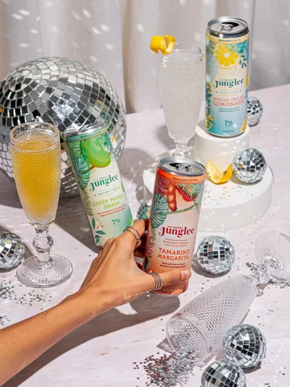 A party-themed shot with disco balls and glitter, associating the beverage brand with fun and celebration.