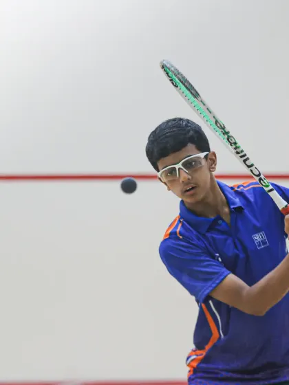 Aryaman Singh mid-swing, showcasing the powerful form he developed through our high-performance squash training program.