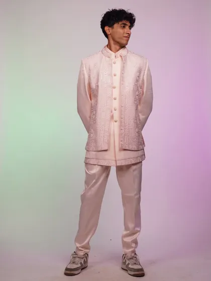 Another view of the pink Indo-western set, showing how the light catches the satin fabric of the pants.