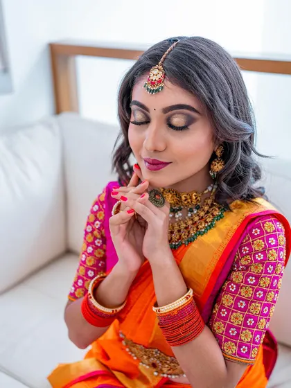 Another angle of the serene pose, showing the flawless base makeup and the soft contouring of the face.