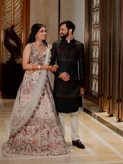 A classic, full-length portrait of the couple in their elegant reception attire.