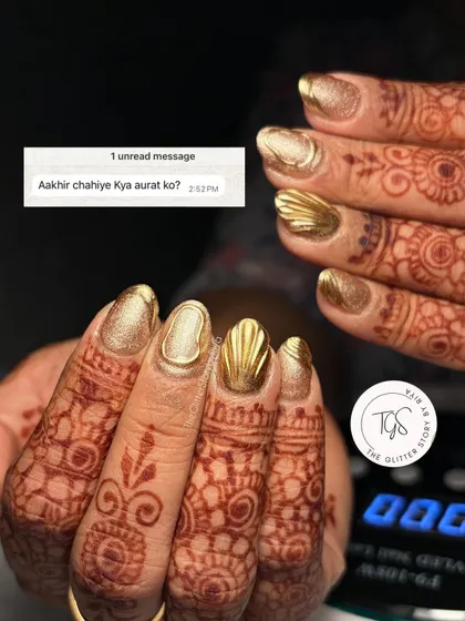 A funny take on what women want: beautiful nails! This shot showcases a full set of solid gold chrome nails with a 3D textured accent, perfect for a bride who loves gold.