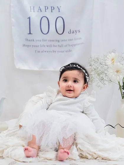 Celebrating 100 days is a beautiful milestone. We created this clean and angelic all-white setup to capture the sweetness of this special moment.