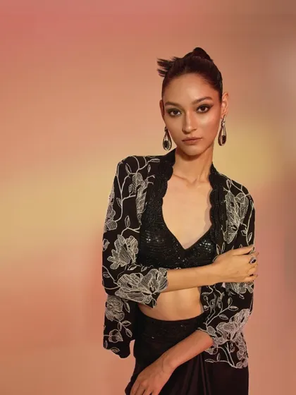 This is an example of my contemporary festive styling. I paired a sequined bralette and draped skirt with an intricately embroidered jacket to craft a modern, edgy look for evening celebrations.