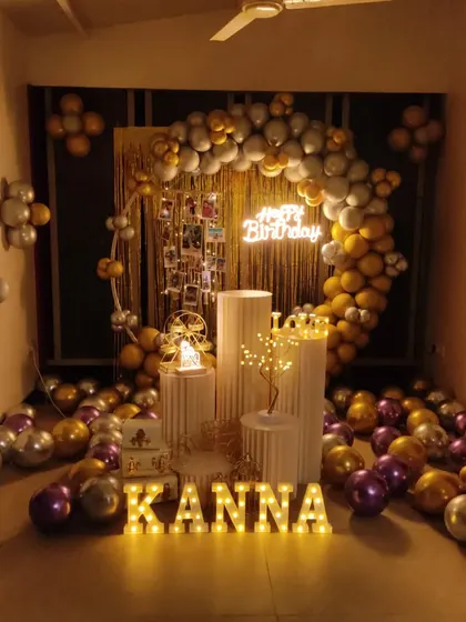 A birthday setup featuring a photo display integrated into the balloon arch, allowing for a personal touch.
