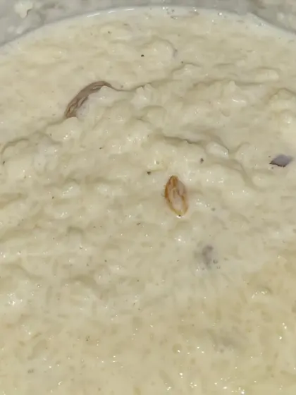 A bowl of our homemade style Kheer, a creamy rice pudding cooked with milk, sugar, and dry fruits.