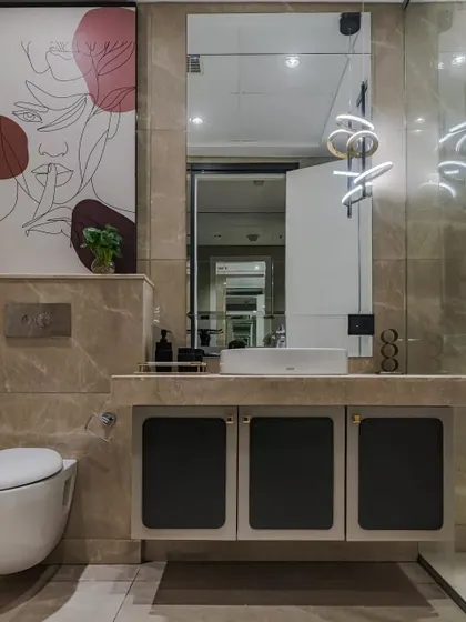 Step into luxury with this elegantly designed bathroom featuring stunning marble finishes, a floating vanity with bold matte accents, and chic contemporary lighting. A touch of artistic flair and sleek details elevate the ambiance to pure sophistication.