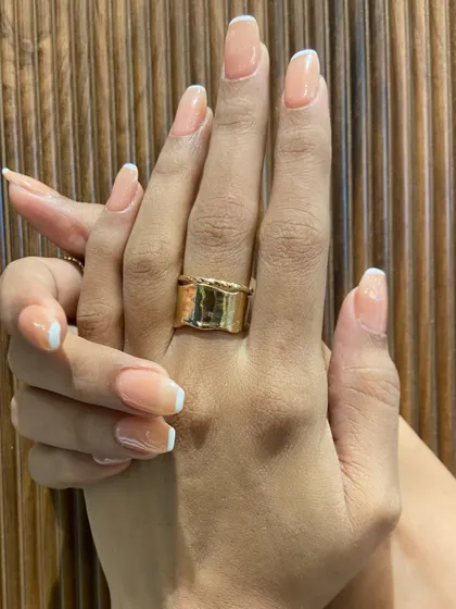 A close-up of the finished look against a textured background. Notice the clean lines and the healthy, glossy shine of the gel extensions.